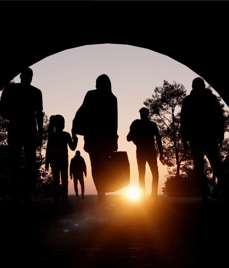 Silhouetted family walking through arch at sunset